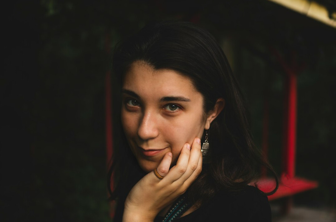 Portrait of a young woman with dark hair smiling